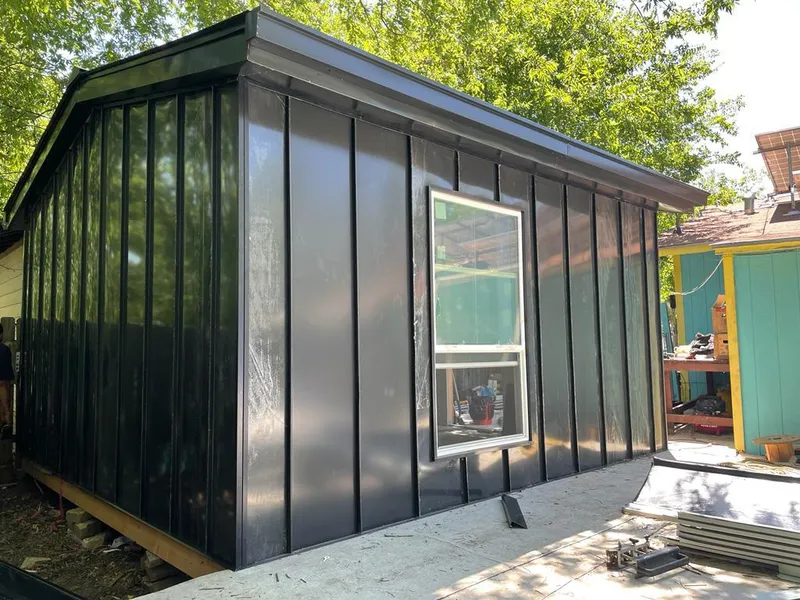 Black standing seam metal wall panels for Roof Inspection in Estelle